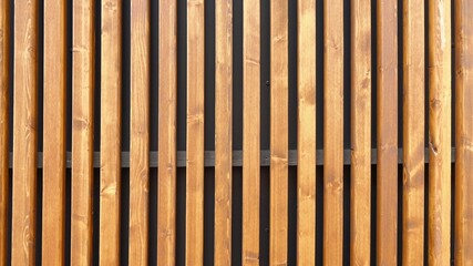 Modern outside wall covering with vertical wooden slats for texture or background. Contemporary...