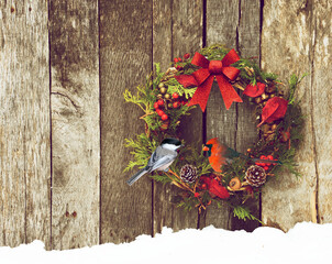 Rustic Christmas wreath with a pretty bird perched inside.