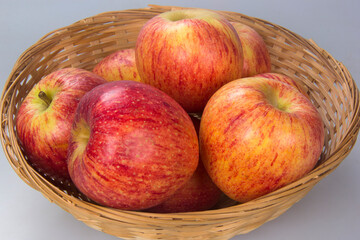 Basket with several apple selected. White background.