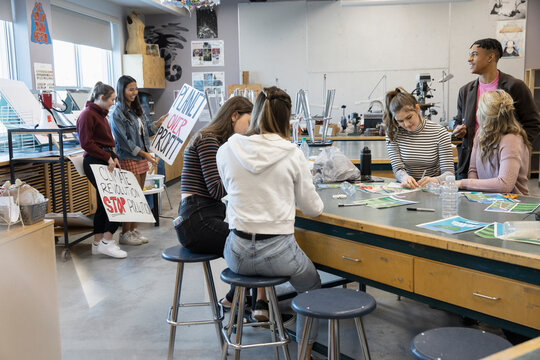 High school students preparing for environmental rally in classroom