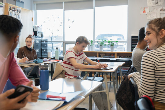 High School Students Talking And Studying In Classroom