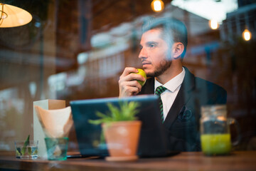 Handsome bearded Hispanic businessman at the coffee shop