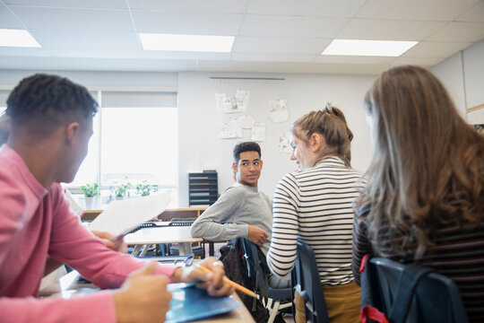 High school students talking in classroom