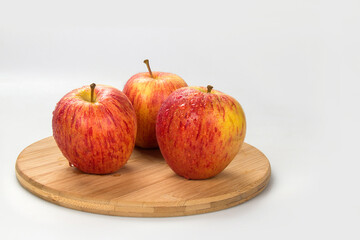 Fresh apples selected under wooden board.