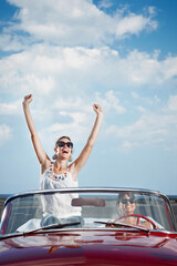Happy Women Driving Rented Convertible Car For Vacations