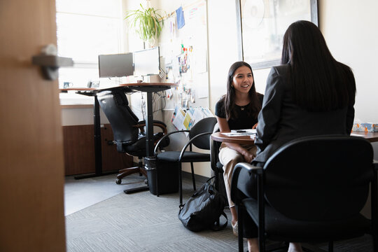 High School Student Meeting With Guidance Counselor In Office