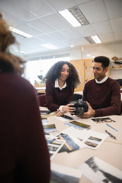 High school students with SLR camera in photography class