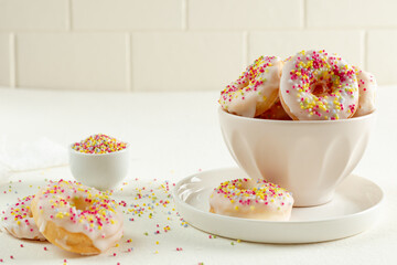donuts with icing sugar in a bowl