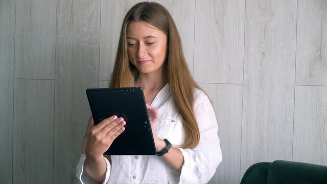 Woman secretary working on tablet. Business woman college university student using tablet in office