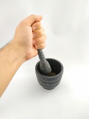 grinding oregano with stone mortar