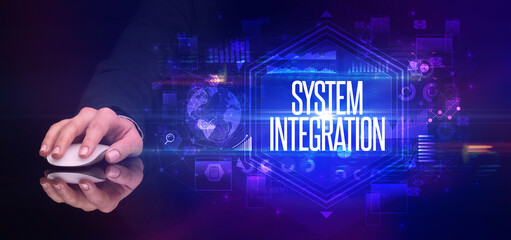 hand holding wireless peripheral with SYSTEM INTEGRATION inscription, cyber security concept