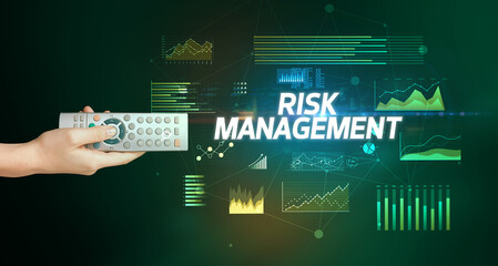 hand holding wireless peripheral with RISK MANAGEMENT inscription, cyber business concept