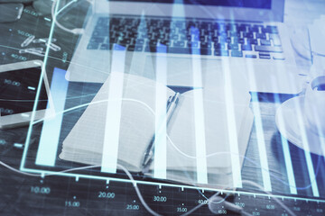 Obraz premium Multi exposure of financial graph drawings and desk with open notebook background. Concept of forex