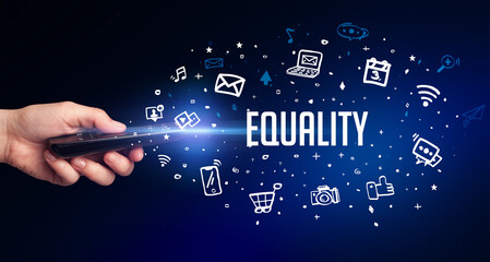 hand holding wireless peripheral with EQUALITY inscription, social media concept