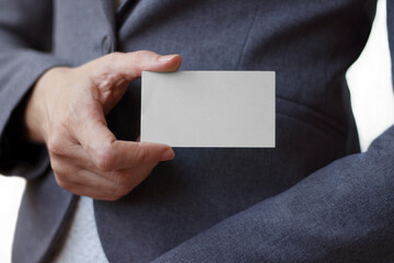 Businesswoman showing and handing a blank business card. Business or finance concept.