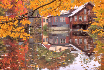 Pond with reflections of autumn leaves and Frey's Measure Mill in Wilton, New Hampshire. Still in...