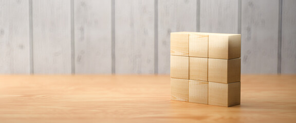 empty wooden cubes for own messages and icons on wooden background