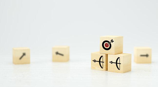 stacked cubes with arrow symbols pointing towards a target on white background
