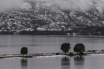 Misty morning on Terraplen's lake during winter season in Esquel, Patagonia, Argentina