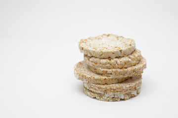 Six brown rice wafers on a white background