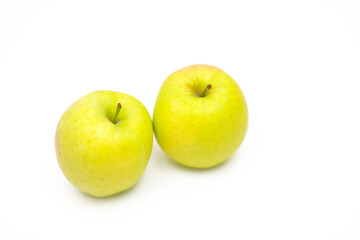 Two fresh yellow apples on a white background.