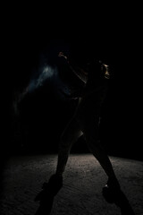 Obraz na płótnie Canvas A man in white flax costume and colored smoke. Dark background