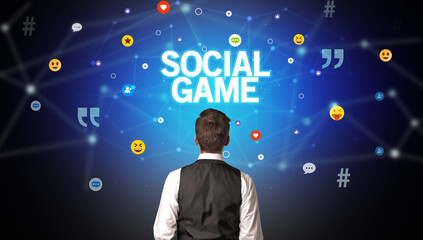 Rear view of a businessman with SOCIAL GAME inscription, social networking concept