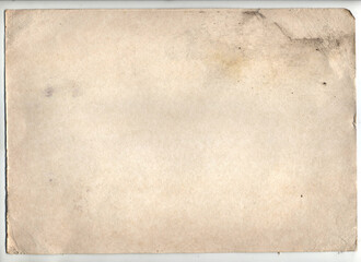 Vintage paper with folds, dark shabby edges, with spots and torn corners.
