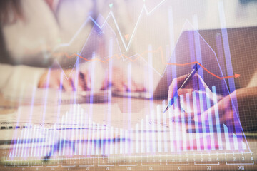 Multi exposure of woman hands typing on computer and forex chart hologram drawing. Stock market analysis concept.