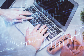 Obraz na płótnie Canvas Multi exposure of woman hands typing on computer and forex chart hologram drawing. Stock market analysis concept.