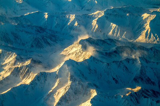 An Aerial View Of Snow Covered Mountain Ranges On A Cold Winter Morning Between Red Devil And Nome Alaska