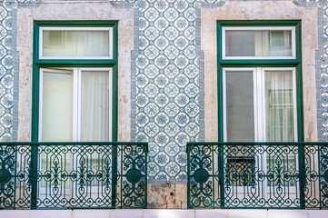 Windows with balconies and typical green mosaic tiles in Lisbon, capital of Portugal