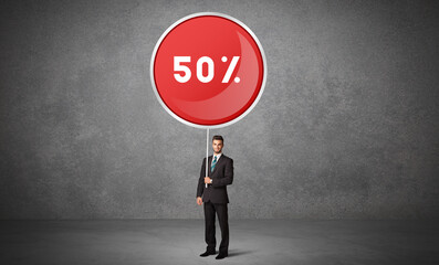 Young business person holdig traffic sign with 50% abbreviation, technology solution concept
