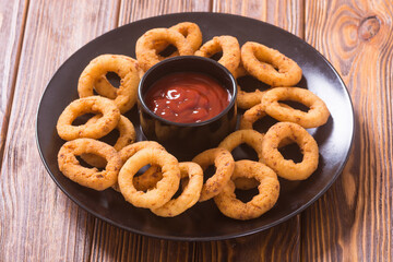 Crunchy fried onion rings and ketchup