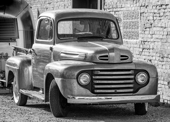 old car in the street black and white