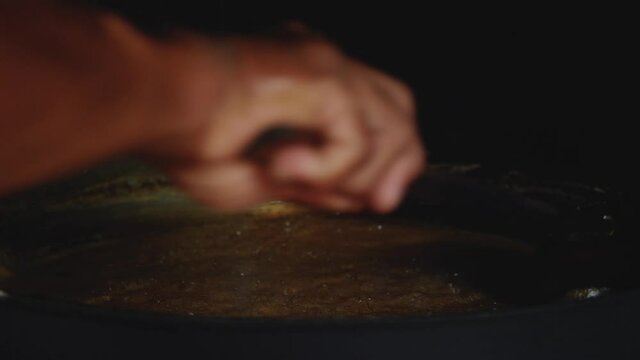 Stirring coconut nectar or neera to make solid organic coconut sugar