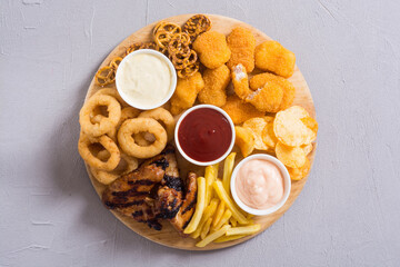 Onion rings , nuggets grilled wings , french fries and mix of snacks