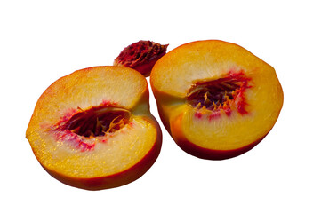 Two halves of a peach and a peach pit.