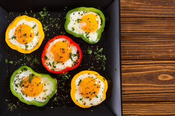 Fototapeta na wymiar Yellow , red and green pepper with fried eggs