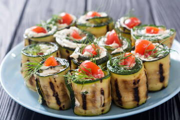 Zucchini rolls with cream cheese , tomatoes and dill