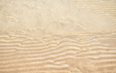 Naklejka na ściany i meble Sand texture sand waves and sand structure outdoors.