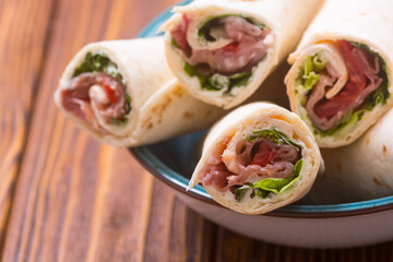 Sliced sandwich tortilla with vegetables and ham