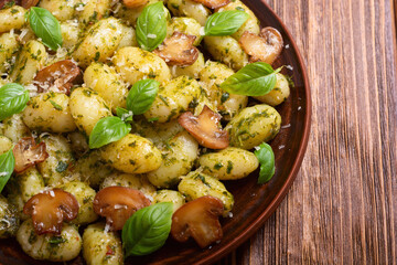 Homemade potatoes gnocchi with basil , cheese and mushrooms
