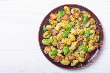 Homemade potatoes gnocchi with basil , cheese and mushrooms