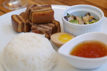 Close up view of Kakuni, Japanese Braised Pork Belly, with rice and soup on white plate. 