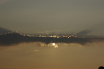 Obraz na płótnie Canvas The sun in the clouds.