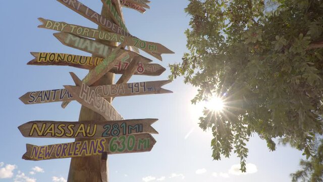 City direction wooden sign post on the beach in Key West Florida USA