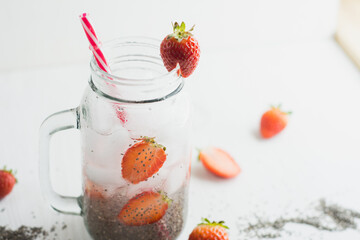 chia seeds and strawberry water, white background.