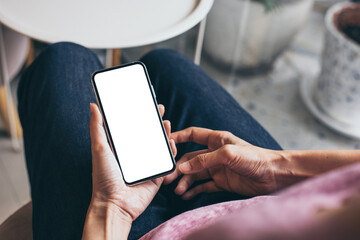 cell phone mockup image blank white screen.woman hand holding texting using mobile on desk at coffee shop.background empty space for advertise.work people contact marketing business,technology