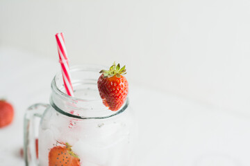 Chia seeds and strawberry water close up, white background.